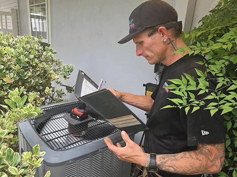 AC technician performing repair in Orange County